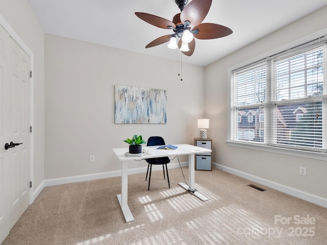 office with light carpet and ceiling fan