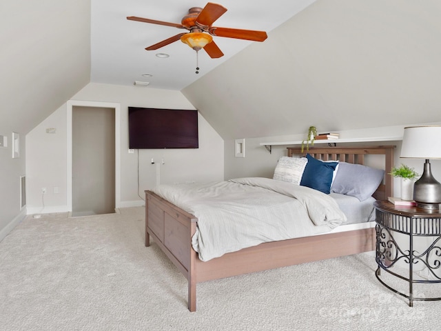 bedroom featuring ceiling fan, vaulted ceiling, and light carpet