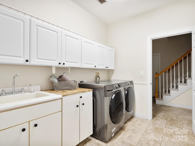 washroom with independent washer and dryer, cabinets, and sink