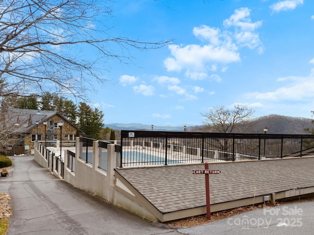 exterior space with a mountain view and a community pool