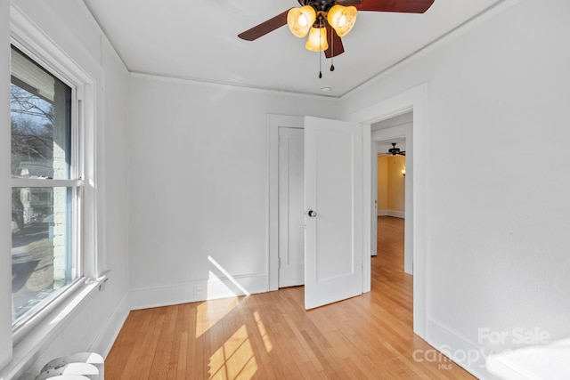 unfurnished room with ceiling fan, light hardwood / wood-style floors, and a wealth of natural light