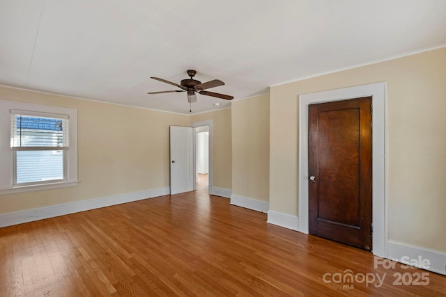 unfurnished room with hardwood / wood-style flooring, ceiling fan, and ornamental molding