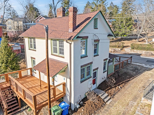 rear view of property with a wooden deck