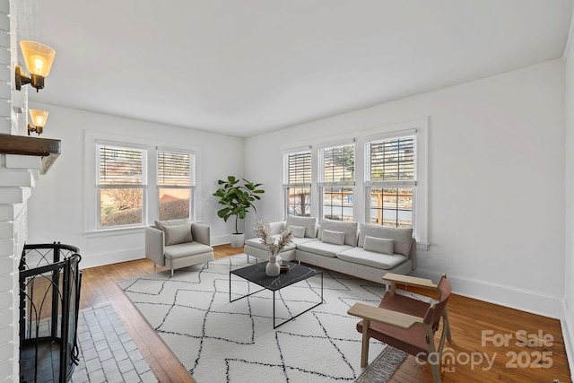 living room featuring a fireplace, hardwood / wood-style flooring, and a wealth of natural light