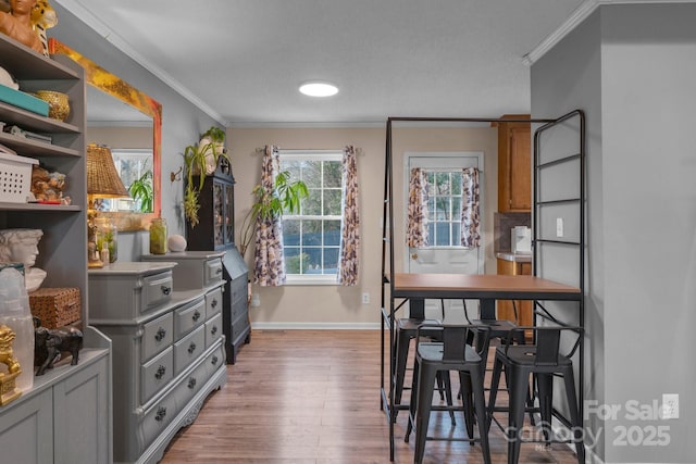 dining area featuring crown molding and light hardwood / wood-style floors