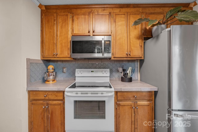 kitchen with stainless steel appliances and decorative backsplash