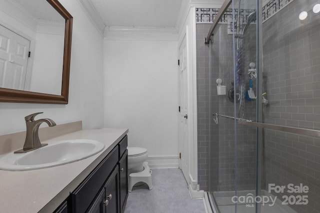 bathroom featuring an enclosed shower, crown molding, vanity, and toilet