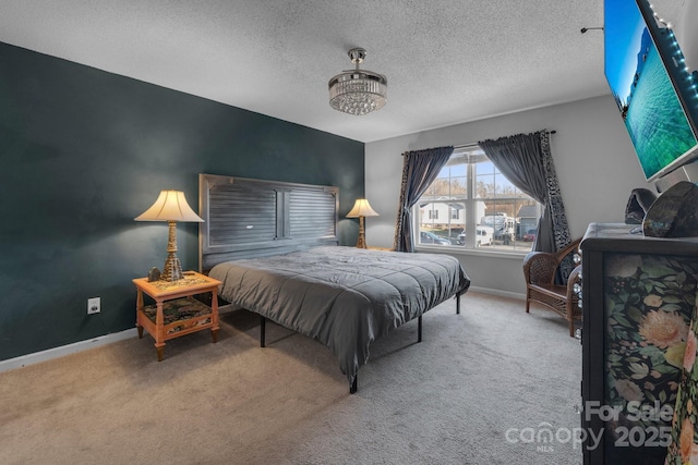 bedroom with a textured ceiling and carpet