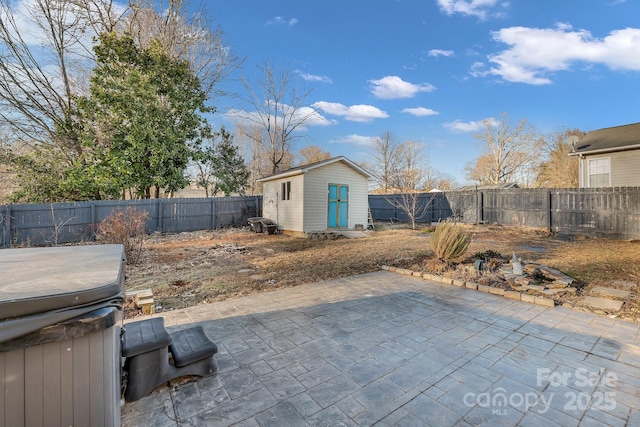 view of patio / terrace featuring a storage shed and a hot tub