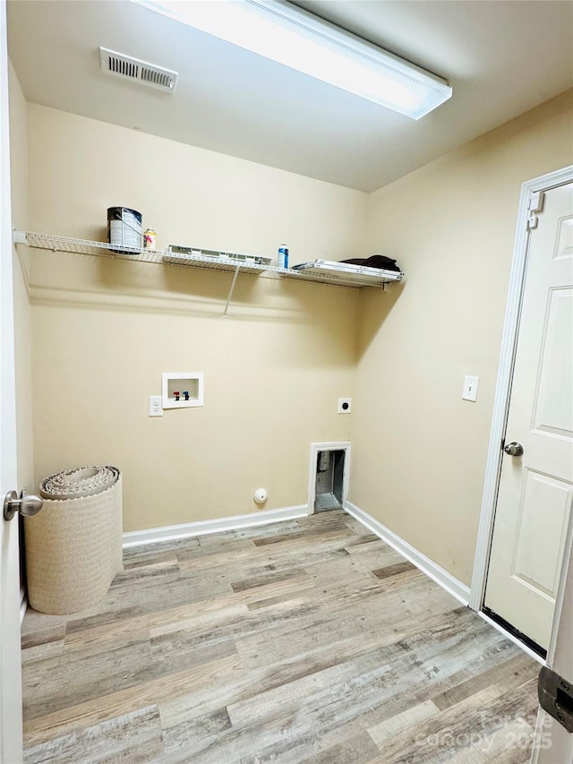 laundry room with washer hookup, visible vents, light wood-type flooring, laundry area, and baseboards