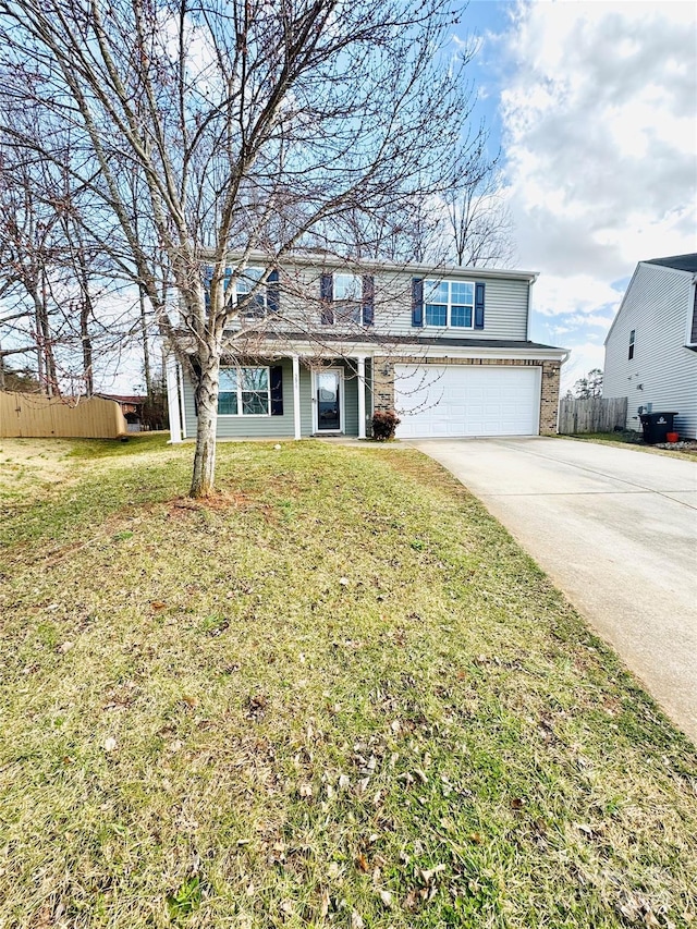 traditional-style house with concrete driveway, an attached garage, fence, and a front yard