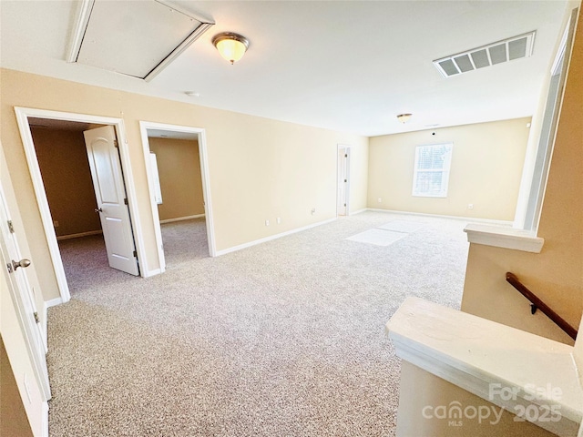 interior space with carpet floors, visible vents, and baseboards