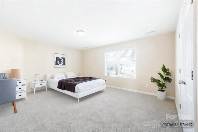 carpeted bedroom with visible vents and baseboards