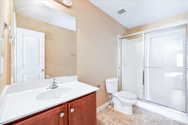 full bathroom featuring toilet, a stall shower, and visible vents