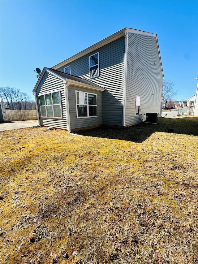 back of property featuring a yard and cooling unit