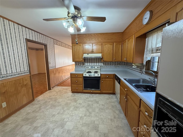 kitchen featuring electric stove, sink, white fridge with ice dispenser, stainless steel dishwasher, and wood walls