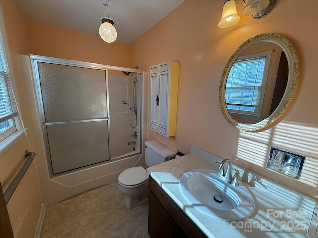 full bathroom with vanity, shower / bath combination with glass door, and toilet