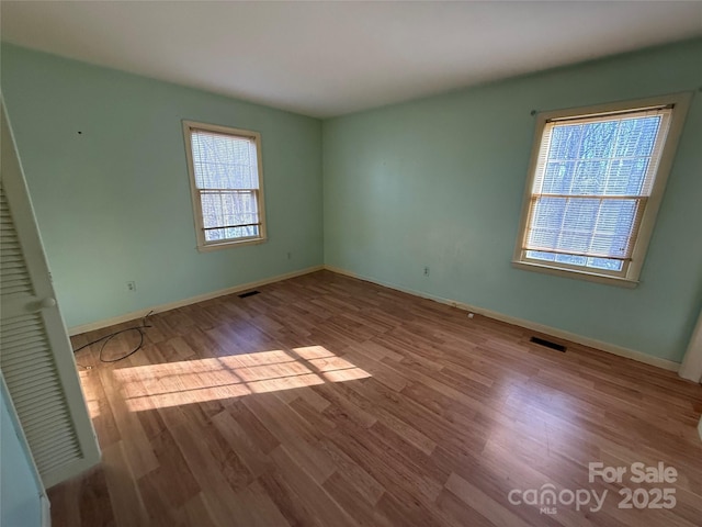 spare room featuring light hardwood / wood-style flooring