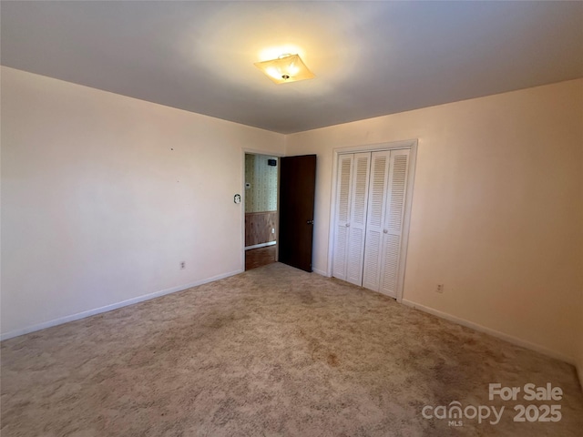 unfurnished bedroom with carpet and a closet