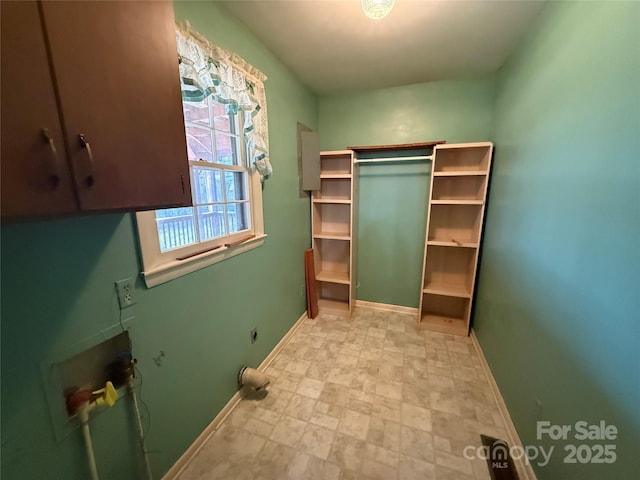 laundry room with cabinets, washer hookup, and electric dryer hookup