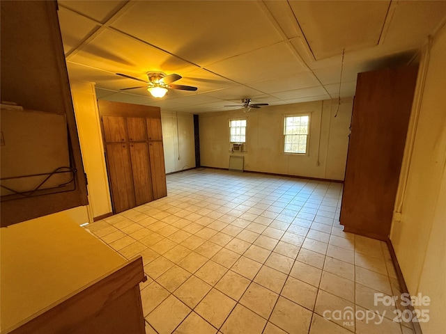 unfurnished room featuring light tile patterned floors and ceiling fan