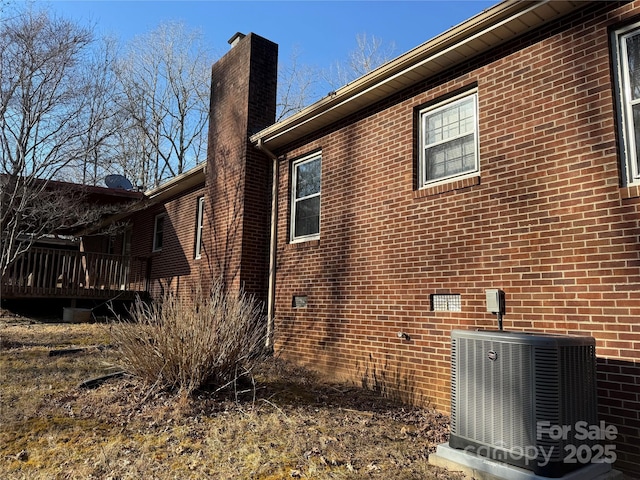 view of property exterior featuring cooling unit and a deck