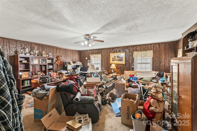 misc room featuring light carpet, ceiling fan, and a textured ceiling