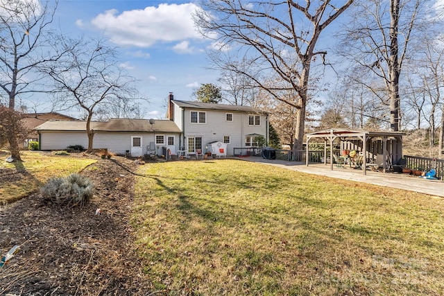 rear view of property with a patio area and a lawn