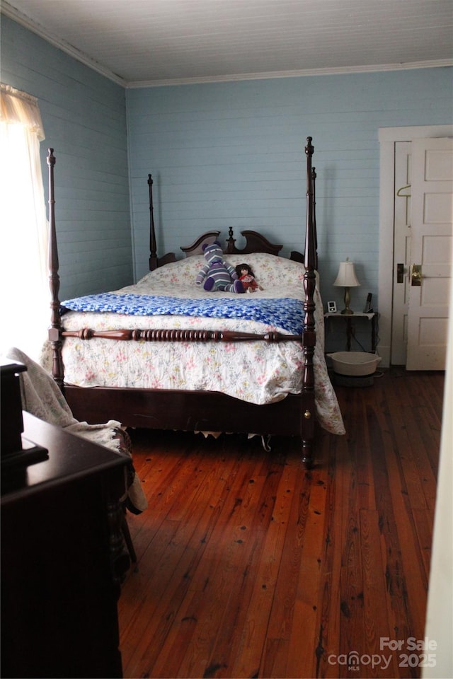 bedroom with dark wood-type flooring and ornamental molding