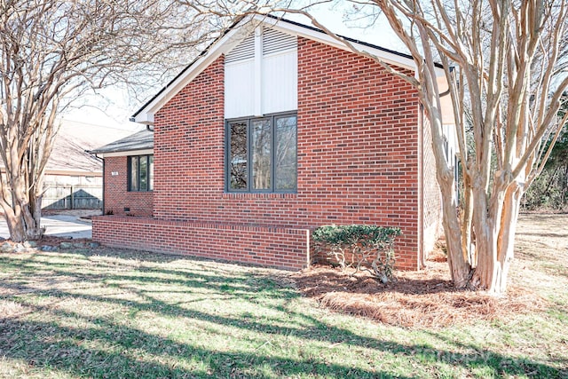 view of home's exterior with a yard