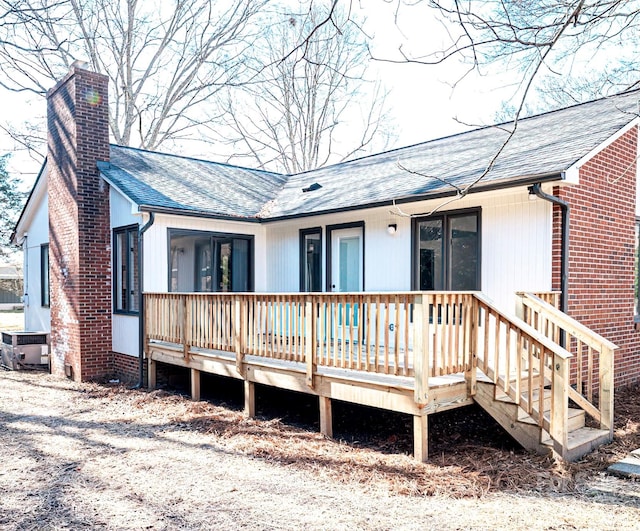 back of house with a wooden deck