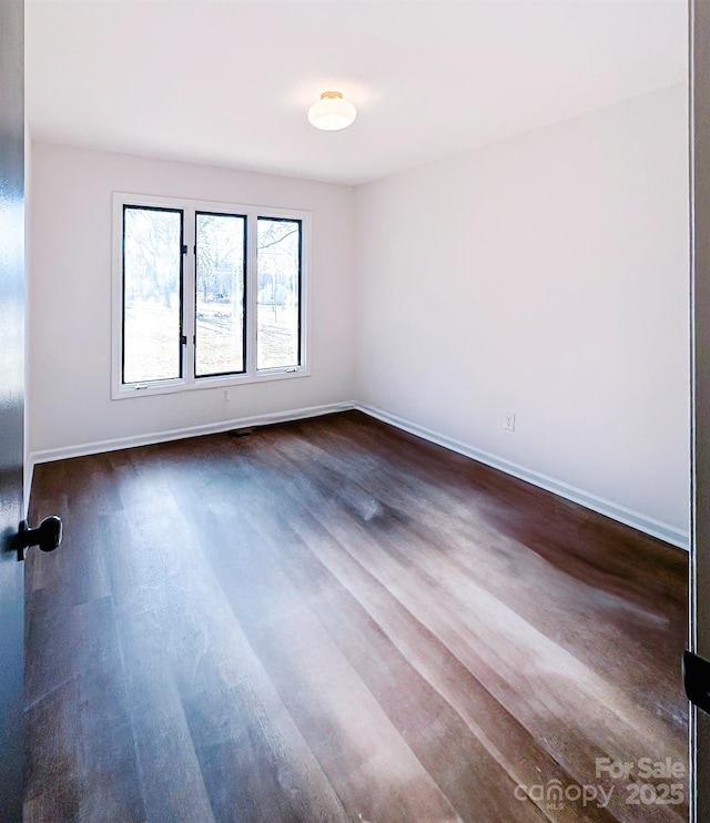 unfurnished room featuring dark hardwood / wood-style floors