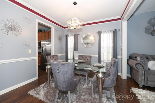 dining room featuring ornamental molding, dark hardwood / wood-style floors, and an inviting chandelier