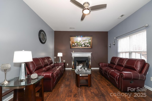 living room with ceiling fan and dark hardwood / wood-style flooring