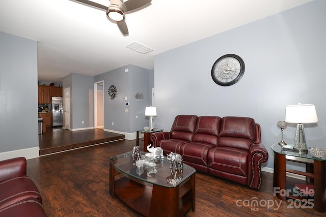 living room with ceiling fan and dark hardwood / wood-style floors