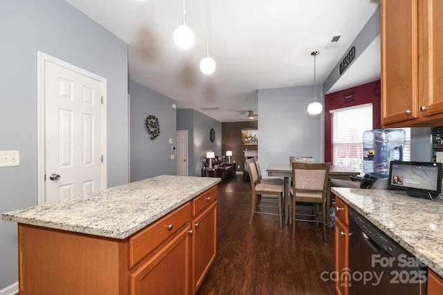 kitchen with hanging light fixtures, dark hardwood / wood-style floors, black dishwasher, a kitchen island, and light stone countertops