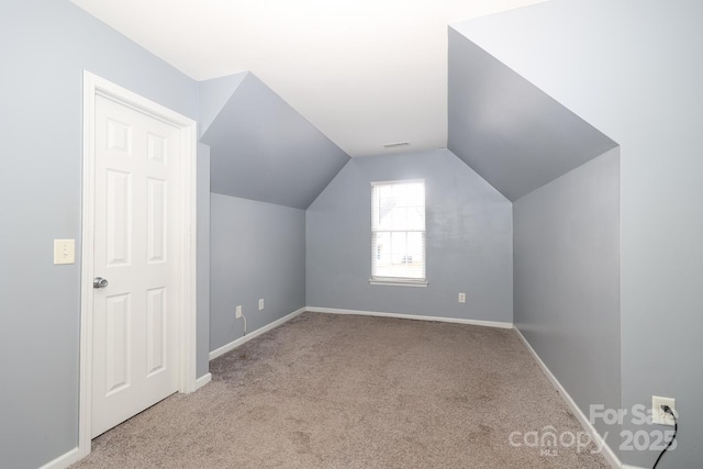 bonus room featuring light colored carpet and lofted ceiling