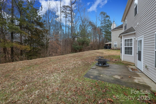 view of yard featuring a fire pit and a patio area