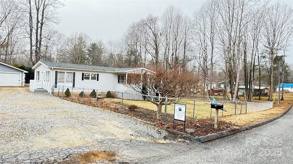 view of front facade featuring an outbuilding and a garage