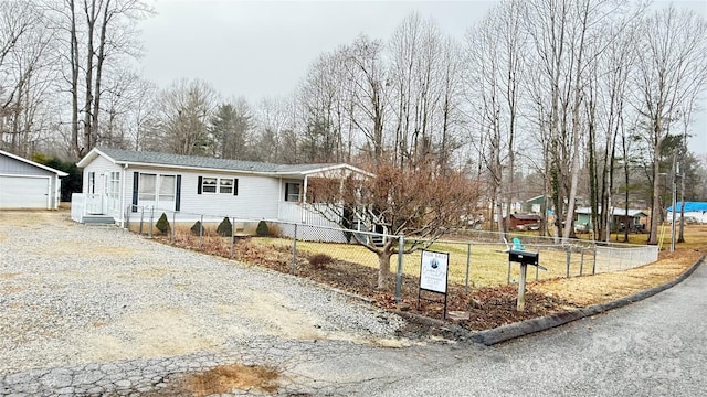 view of front facade featuring an outbuilding and a garage