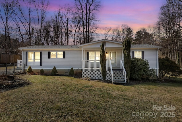 single story home featuring a lawn and a porch