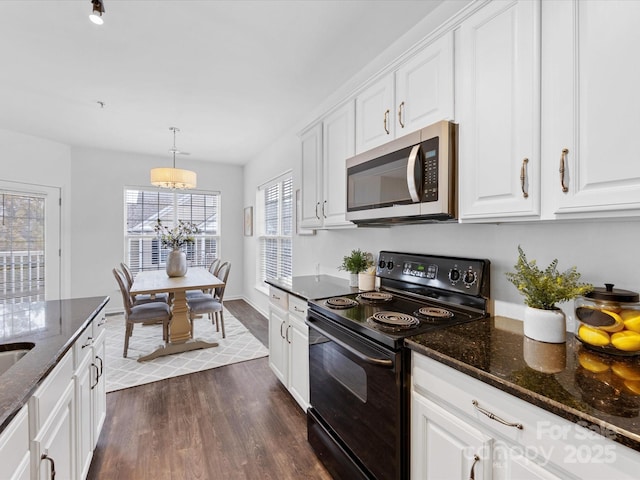 kitchen with decorative light fixtures, white cabinetry, black electric range oven, dark stone countertops, and dark wood-type flooring