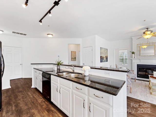 kitchen featuring sink, dark hardwood / wood-style floors, dishwasher, a kitchen island with sink, and white cabinets