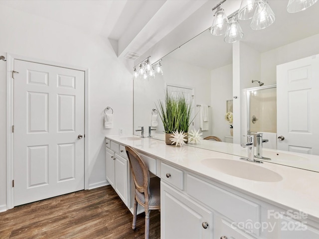 bathroom with hardwood / wood-style flooring, vanity, an enclosed shower, and toilet