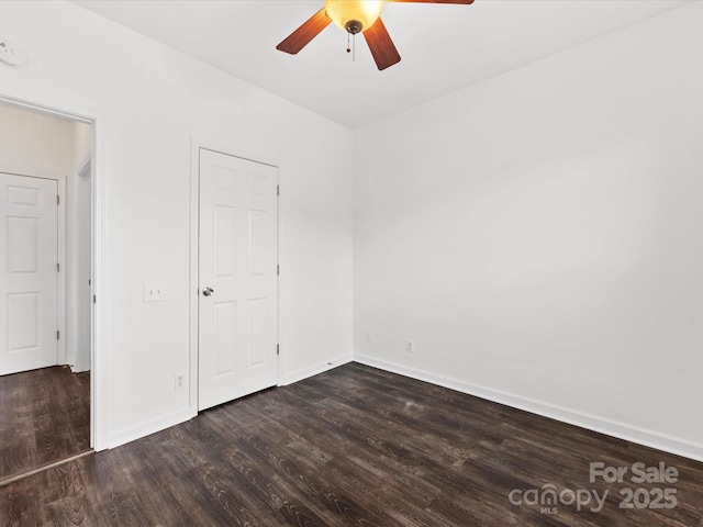 unfurnished bedroom featuring dark wood-type flooring and ceiling fan