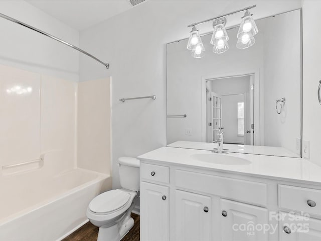 full bathroom featuring shower / bath combination, vanity, wood-type flooring, and toilet