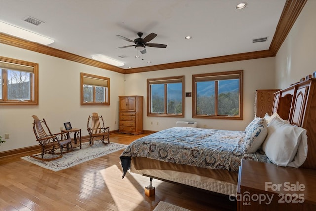 bedroom with crown molding and light wood-type flooring