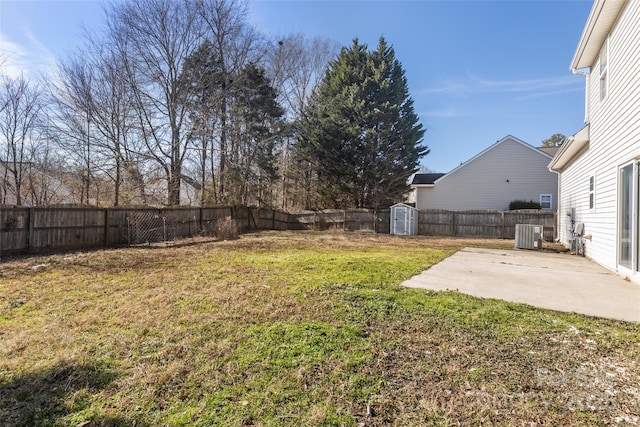 view of yard featuring cooling unit, a shed, and a patio area