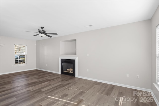 unfurnished living room with ceiling fan and wood-type flooring