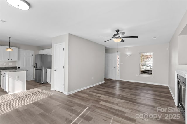 unfurnished living room with hardwood / wood-style flooring and ceiling fan